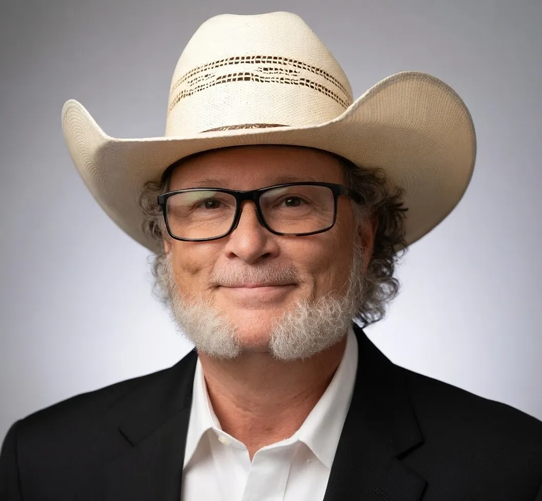 Dr. Brooks McKenzie in a white cowboy hat and dark jacket